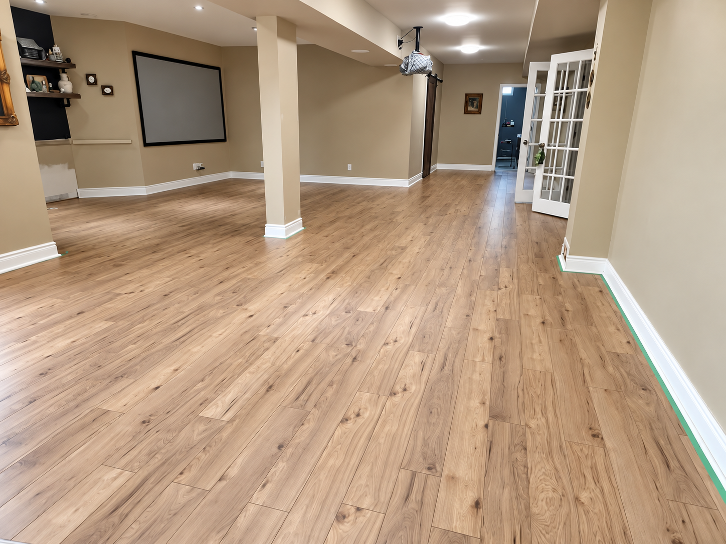 Light wood-look flooring across a spacious finished room